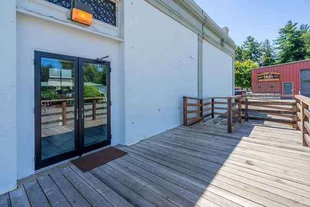 a view of a house with sitting area and wooden bench