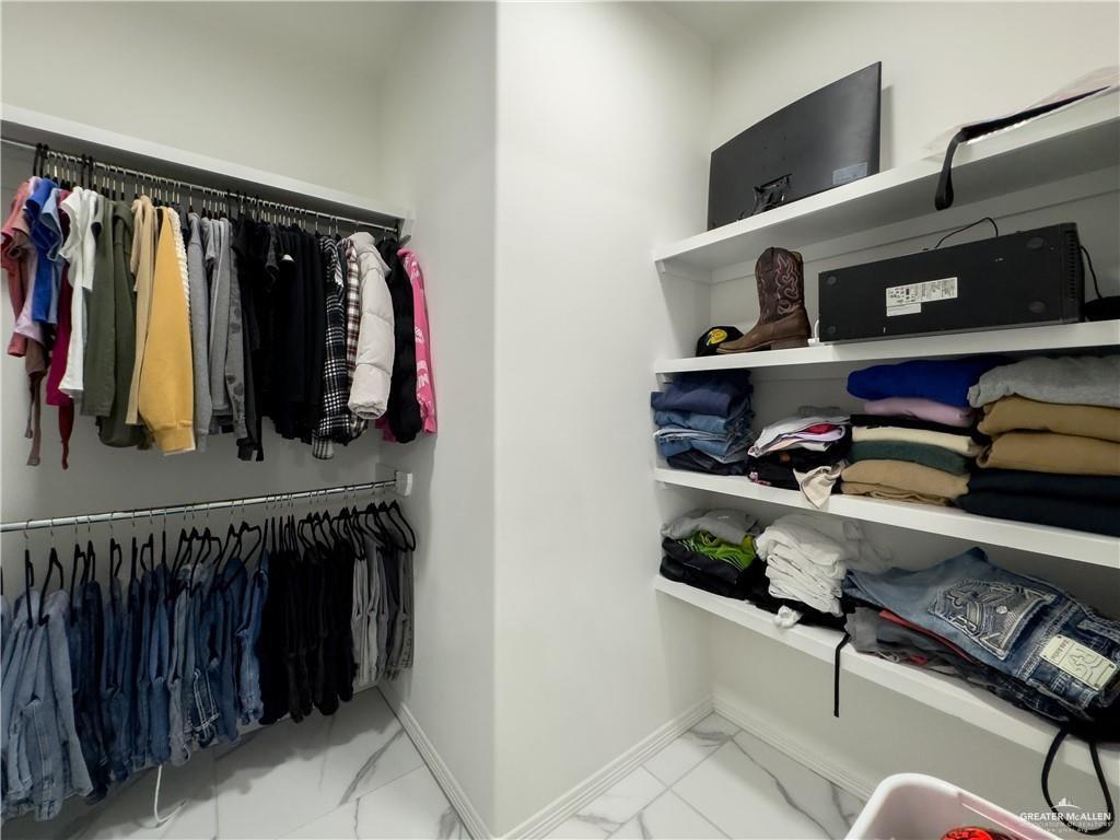 620 Oaxaca Street Alton, TX 78573 - Photo 11 of 23 a view of walk in closet with clothes and shoes