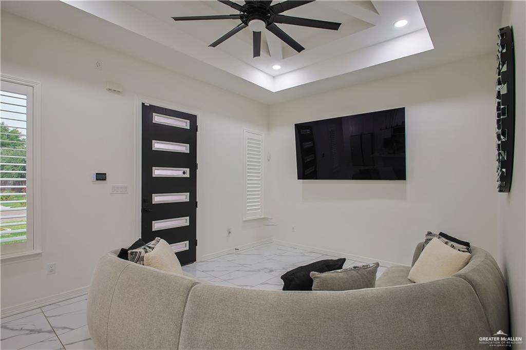 620 Oaxaca Street Alton, TX 78573 - Photo 3 of 23 a living room with furniture and a flat screen tv
