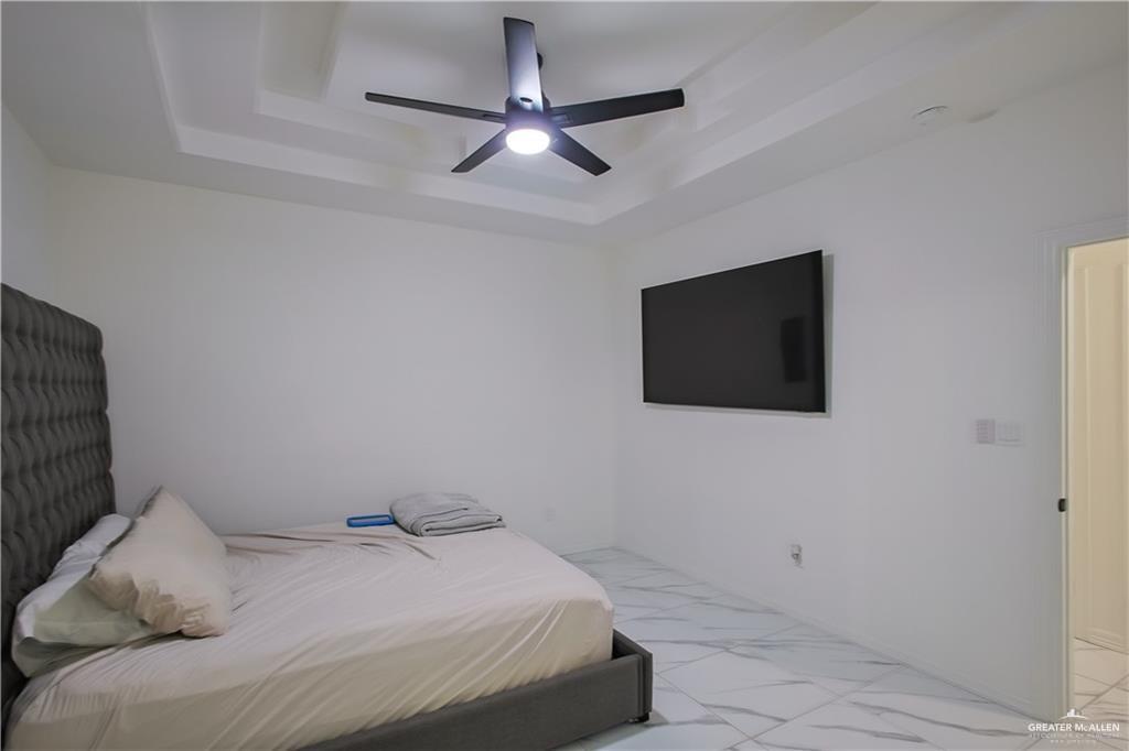 620 Oaxaca Street Alton, TX 78573 - Photo 8 of 23 a bedroom with a bed and a flat screen tv