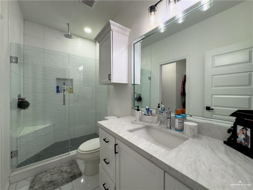620 Oaxaca Street Alton, TX 78573 - Photo 9 of 23 a bathroom with a sink a toilet and shower