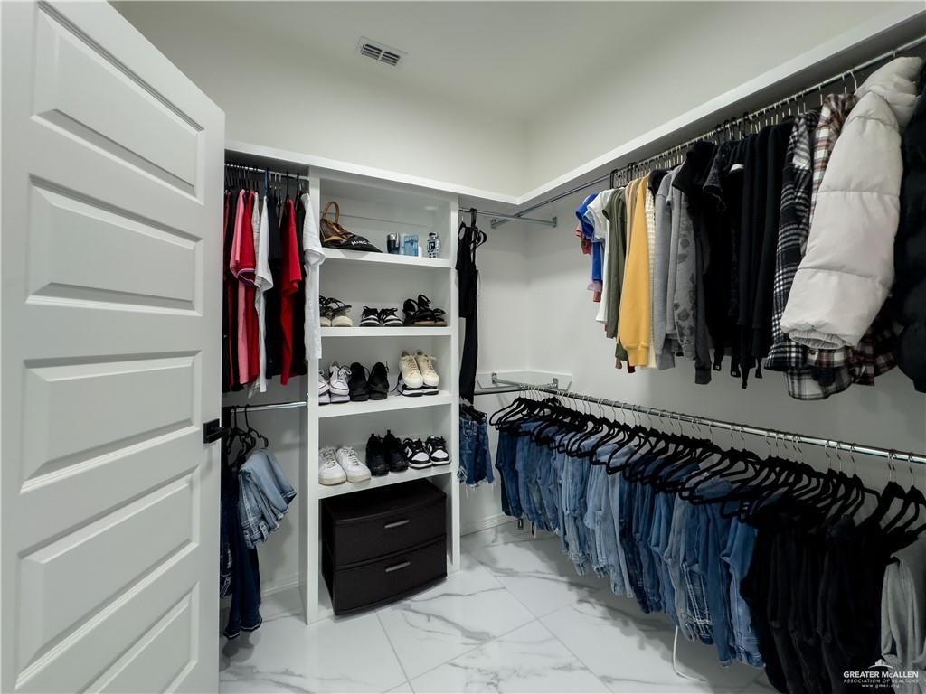 620 Oaxaca Street Alton, TX 78573 - Photo 10 of 23 a view of walk in closet with clothes and shoes
