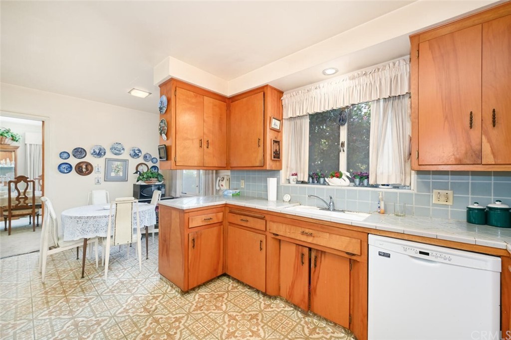 9505 Raviller Drive Downey, CA 90240 - Photo 23 of 54 a kitchen with a sink cabinets and window