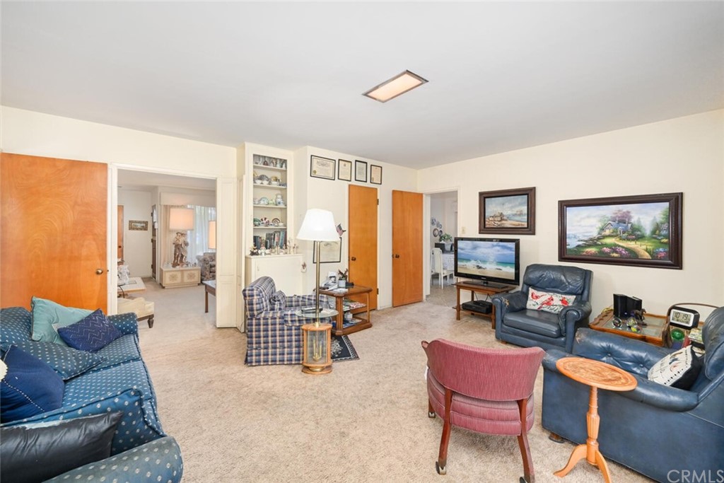 9505 Raviller Drive Downey, CA 90240 - Photo 28 of 54 a living room with furniture a flat screen tv and a large window