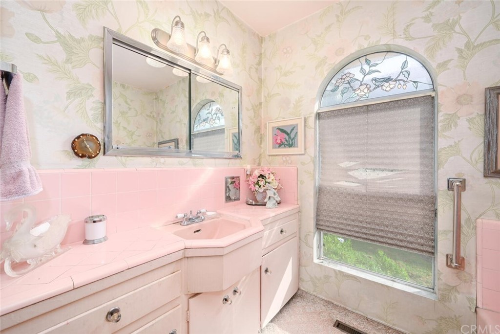 9505 Raviller Drive Downey, CA 90240 - Photo 41 of 54 a bathroom with a sink and a mirror