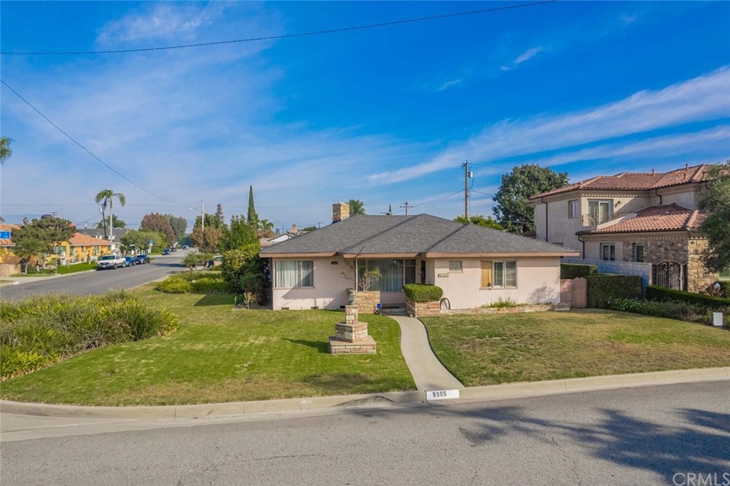 9505 Raviller Drive Downey, CA 90240 - Photo 51 of 54 a view of a white house with a yard table and chairs