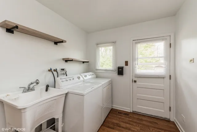 a utility room with cabinets washer and dryer