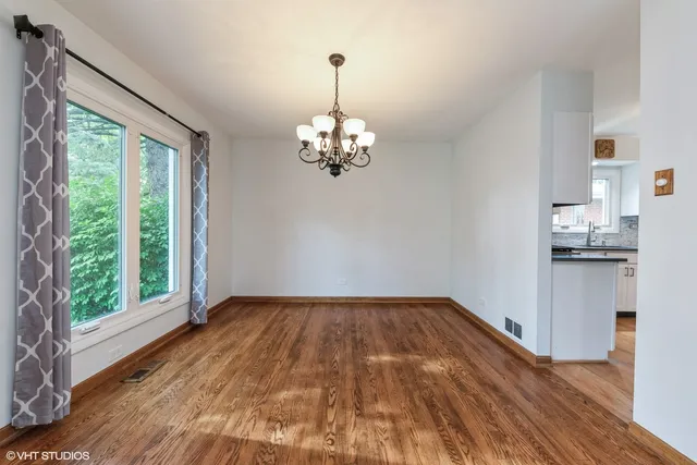 a view of a room with wooden floor and a window