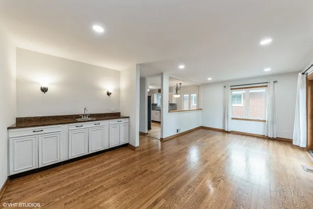 a large kitchen with hard wood floors and stainless steel appliances