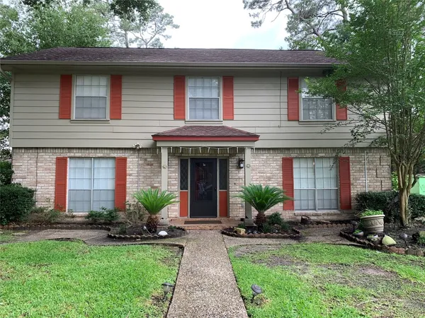 a front view of a house with porch and garden