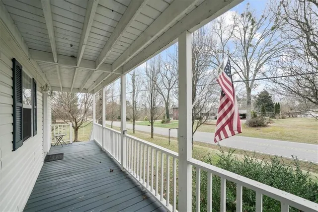 a view of a wooden deck next to a yard