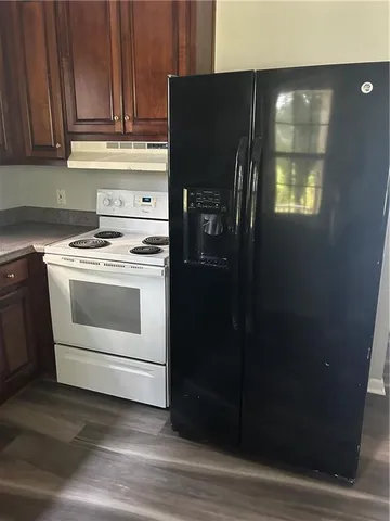 a kitchen with a refrigerator and a stove