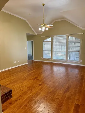 a view of a hallway with furniture and a window