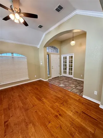 a view of empty room with wooden floor
