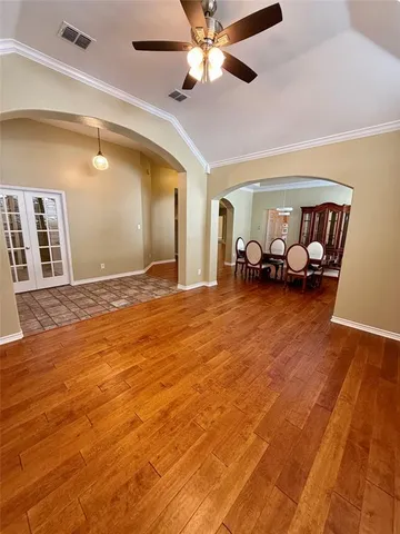 a view of a room with furniture and wooden floor