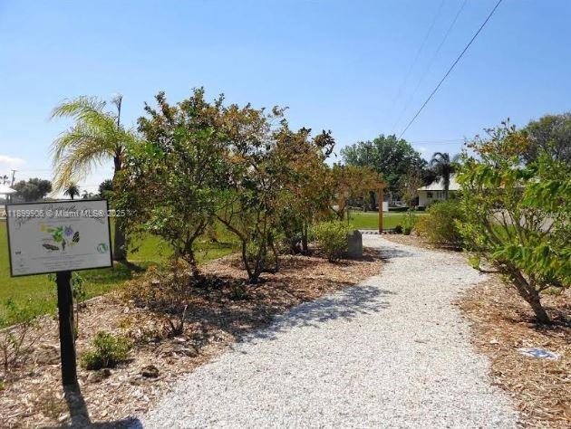 3147 Trevino Terrace, Unit 2 Punta Gorda, FL 33983 - Photo 16 of 24 a view of a street sign under a large tree