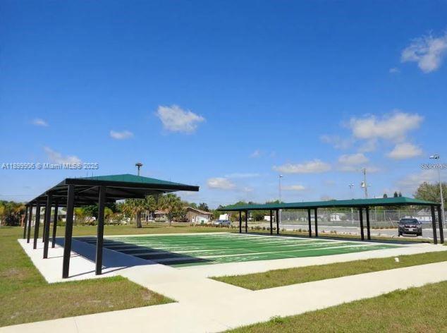 3147 Trevino Terrace, Unit 2 Punta Gorda, FL 33983 - Photo 18 of 24 a view of a big building with a big yard and large trees