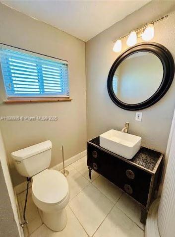 3147 Trevino Terrace, Unit 2 Punta Gorda, FL 33983 - Photo 22 of 24 a bathroom with a toilet a sink and mirror