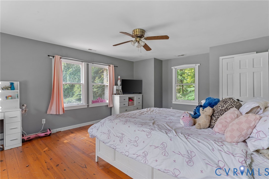 80 Mill Ridge Road Hartfield, VA 23071 - Photo 15 of 43 Hardwood flooring, painted walls, multiple windows