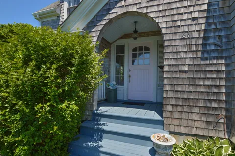 a front view of a house with a garden