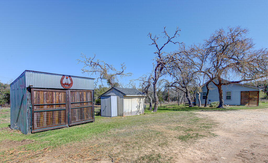 1411 Lone Man Mountain Road Wimberley, TX 78676 - Photo 1 of 1 View of yard featuring an outbuilding and a storage shed