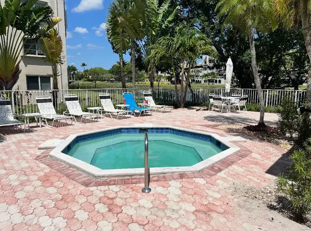 a swimming pool with outdoor seating and yard
