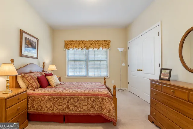 a bedroom with a bed a dresser and a window