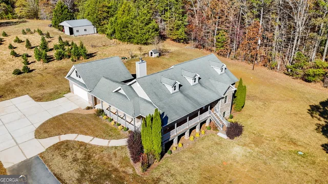 an aerial view of a house with a yard