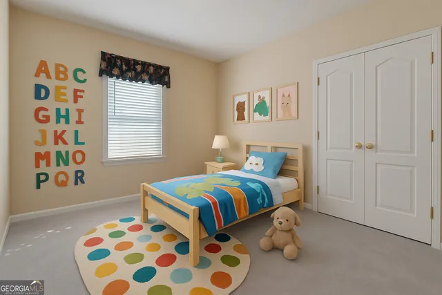 a bedroom with a bed and painting on the wall