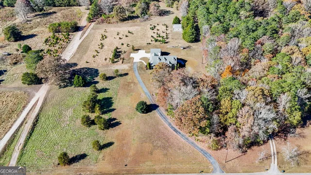 an aerial view of a house with a yard