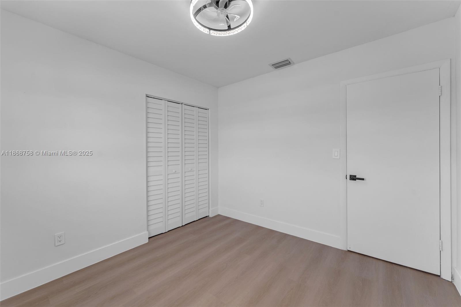 11711 Southwest 181st Terrace Miami, FL 33177 - Photo 13 of 35 wooden floor in an empty room