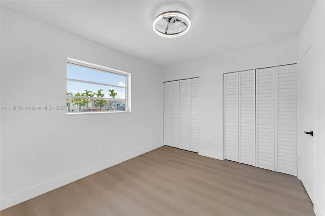 a view of a room with wooden floor