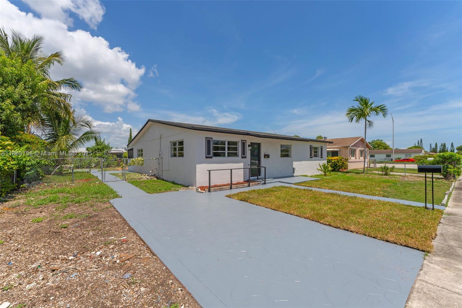 11711 Southwest 181st Terrace Miami, FL 33177 - Photo 2 of 35 a front view of a house with swimming pool having outdoor seating