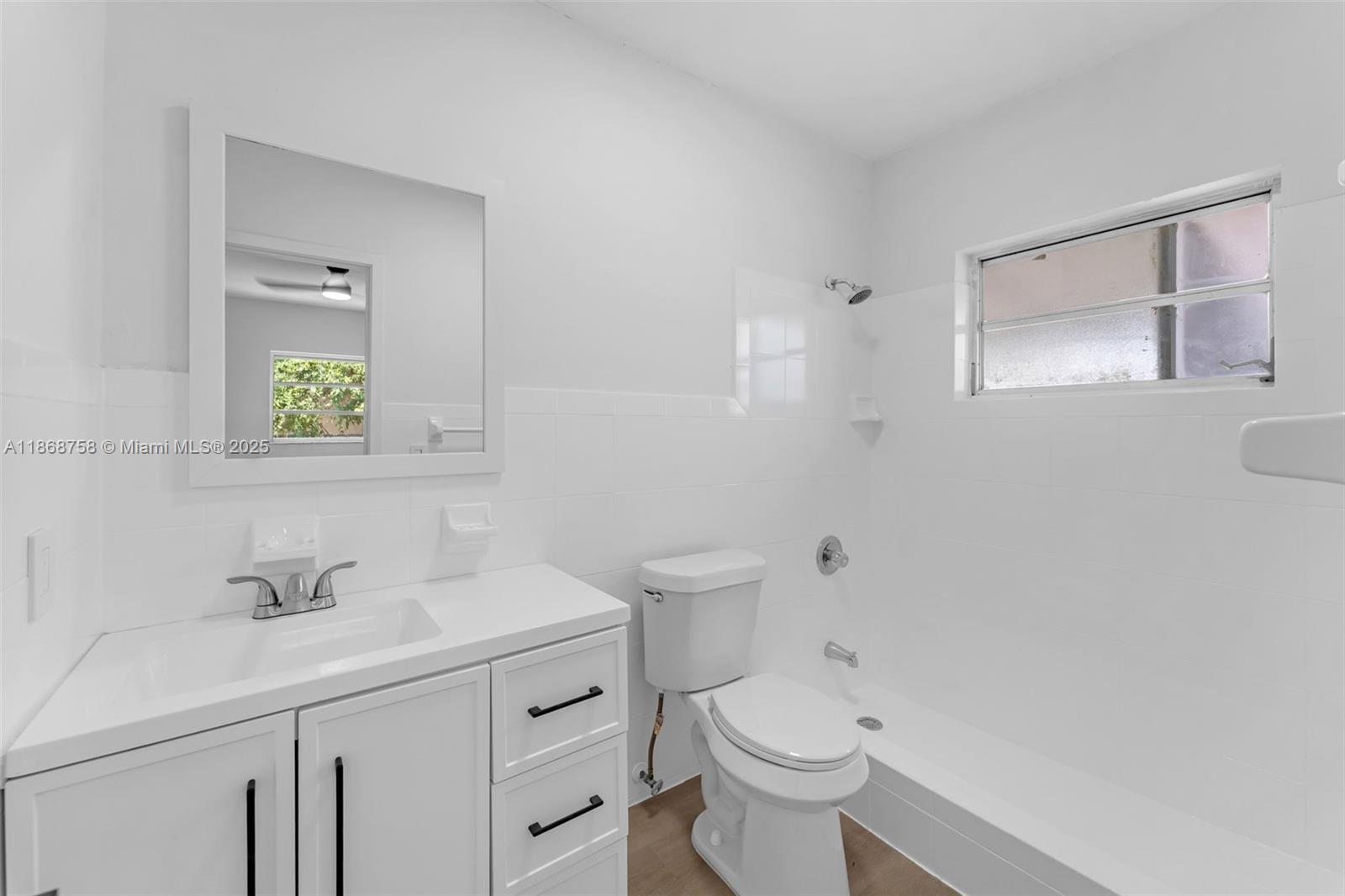 11711 Southwest 181st Terrace Miami, FL 33177 - Photo 25 of 35 a bathroom with a sink a toilet and mirror