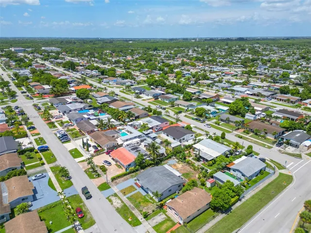 an aerial view of residential houses with outdoor space