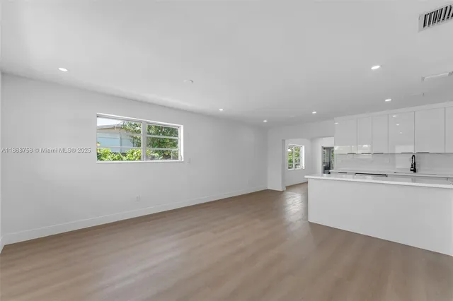 a view of kitchen with wooden floor and window