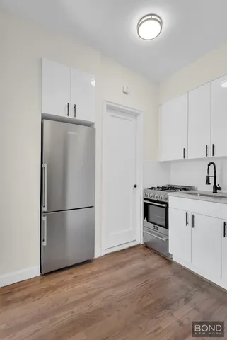 a bathroom with a sink a mirror a toilet and bathtub
