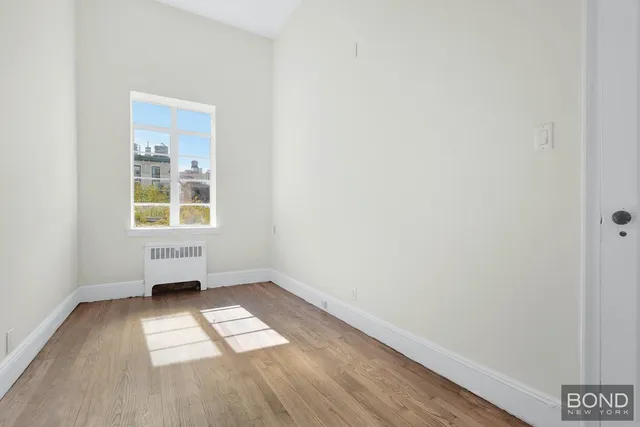 an empty room with wooden floor