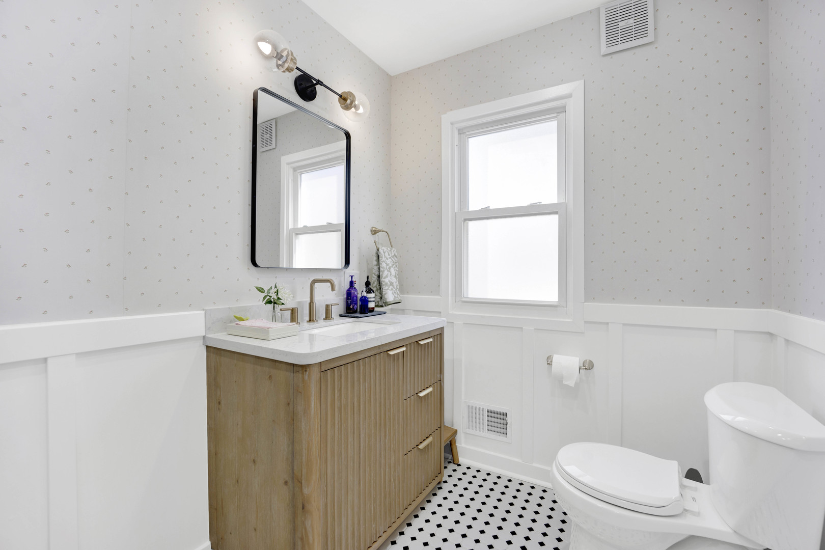 261 Herrick Road Riverside, IL 60546 - Photo 13 of 32 a bathroom with a sink a toilet and a mirror