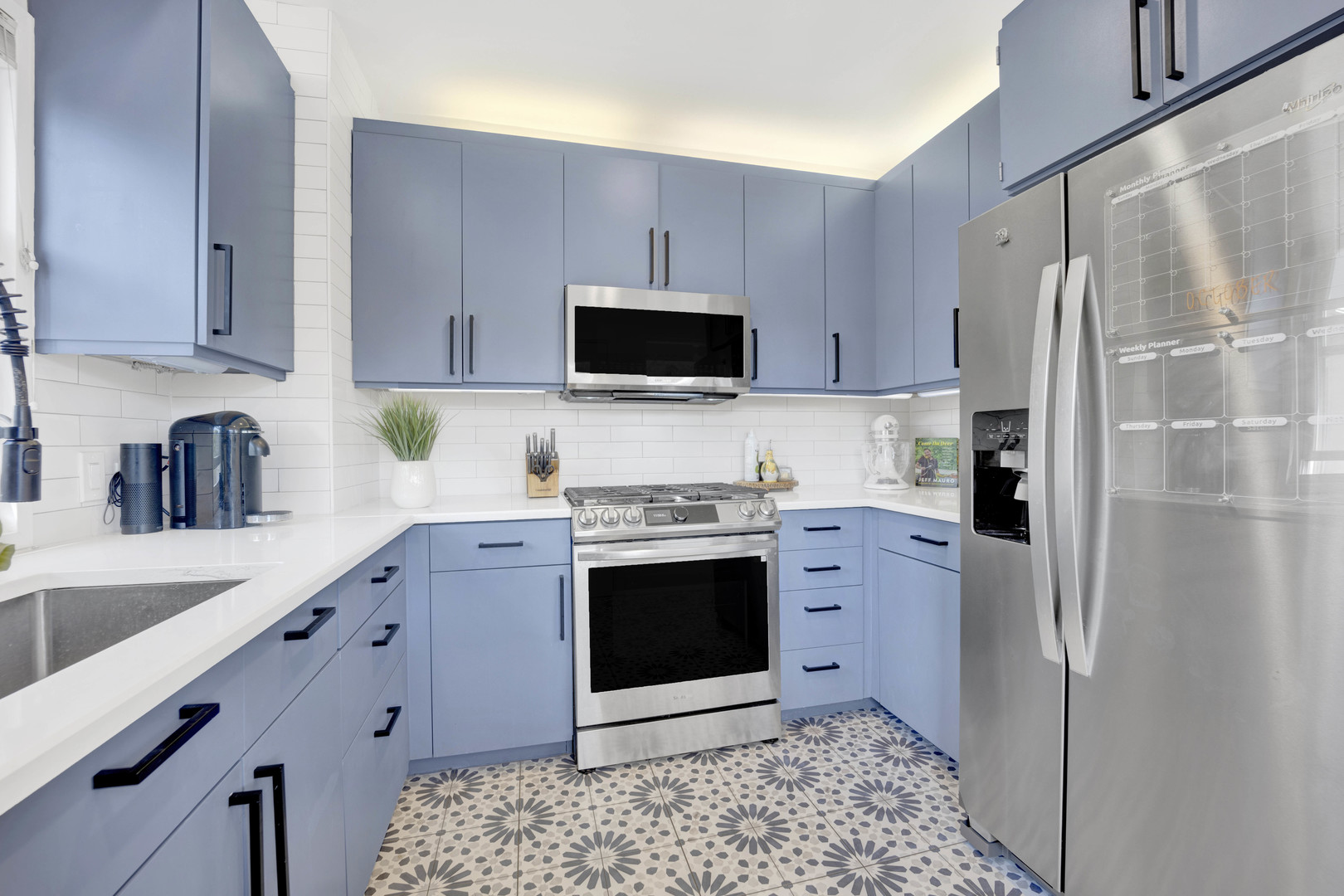 261 Herrick Road Riverside, IL 60546 - Photo 10 of 32 a kitchen with stainless steel appliances a stove a sink and a refrigerator
