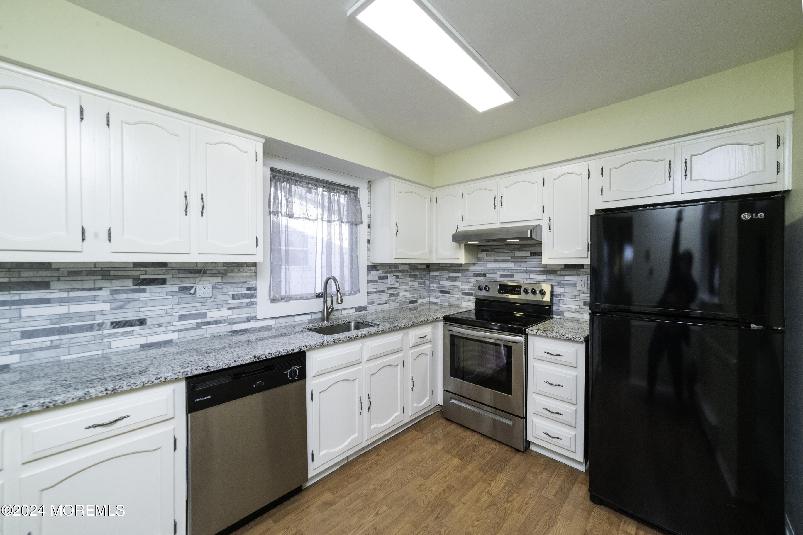 16 Lamb Road Brick, NJ 08724 - Photo 12 of 23 a kitchen with a sink white cabinets and stainless steel appliances