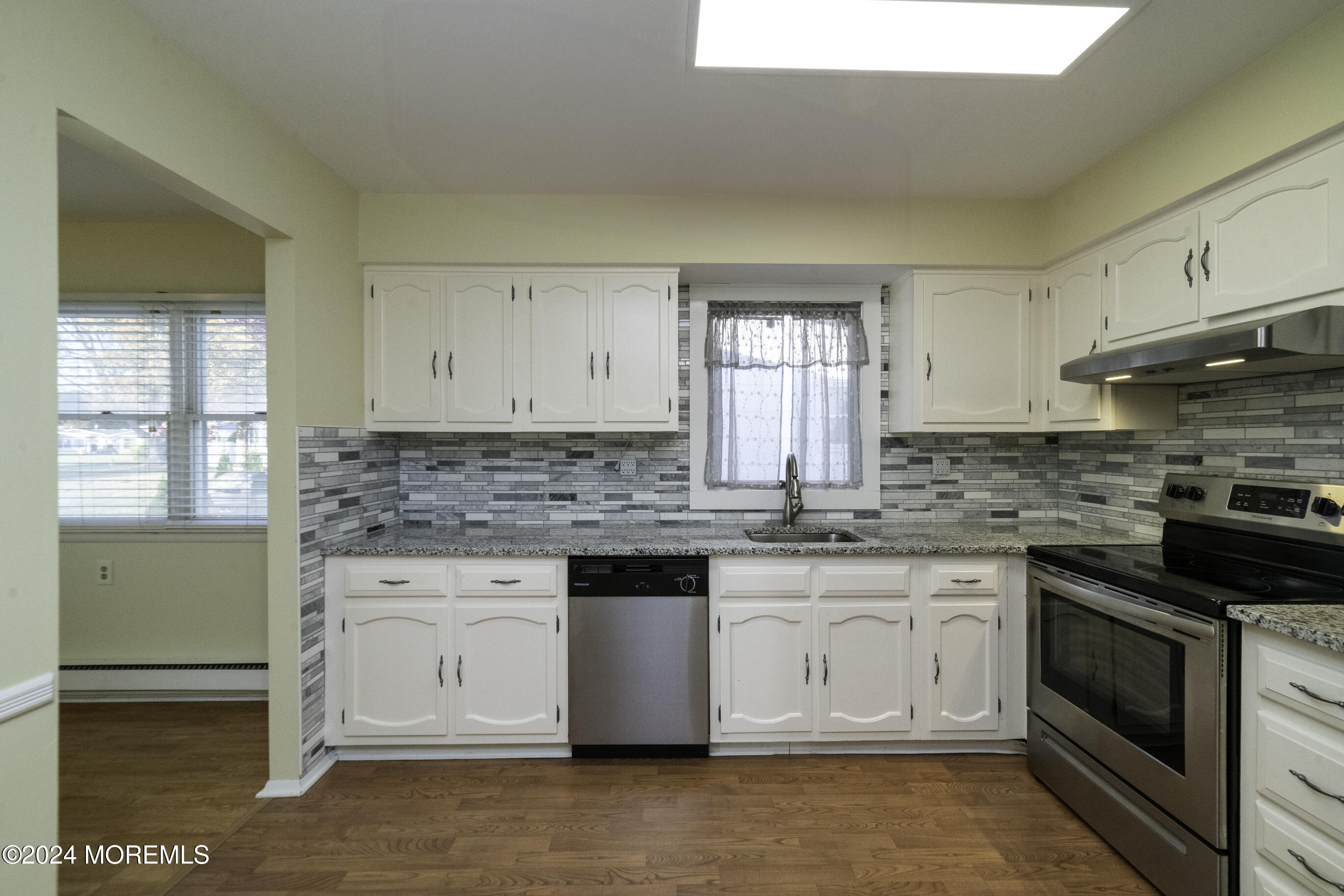 16 Lamb Road Brick, NJ 08724 - Photo 13 of 23 a kitchen with stainless steel appliances granite countertop a stove a sink and a microwave