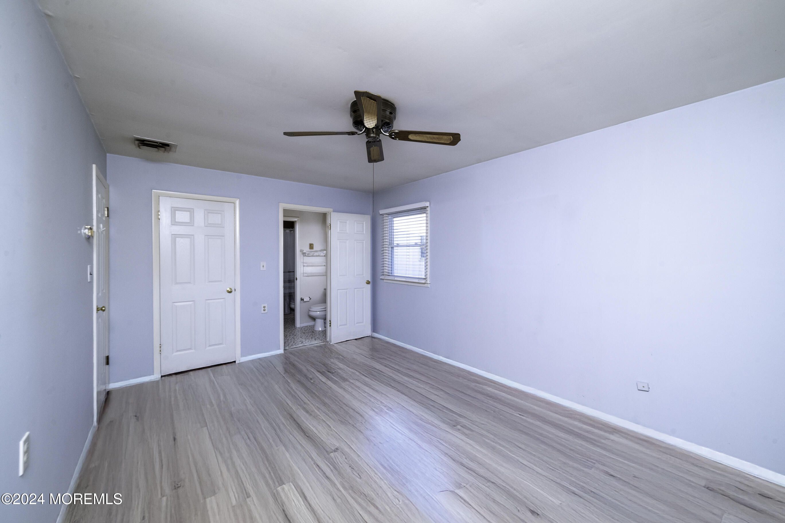 16 Lamb Road Brick, NJ 08724 - Photo 16 of 23 a view of a room with wooden floor and ceiling fan