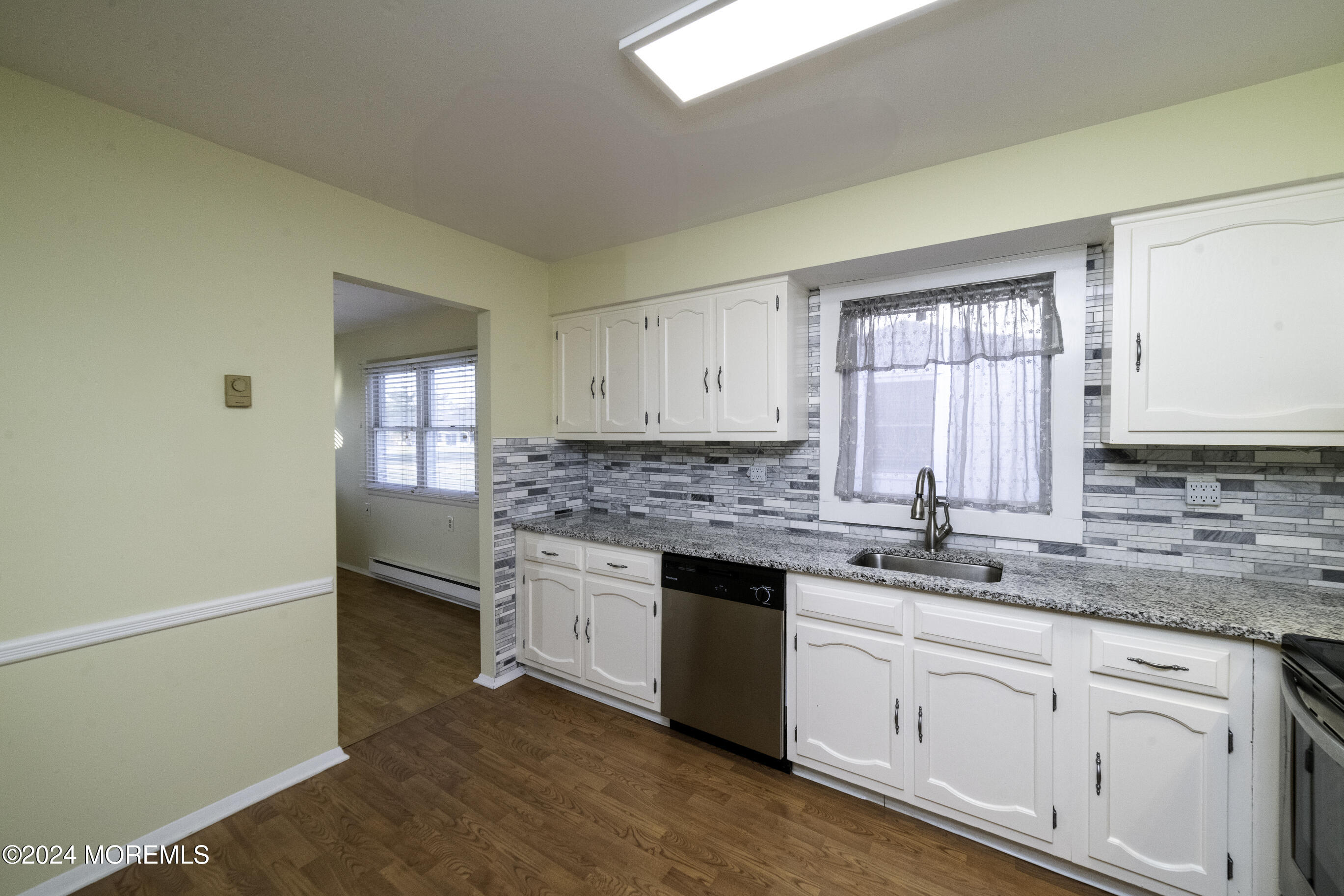 16 Lamb Road Brick, NJ 08724 - Photo 10 of 23 a kitchen with granite countertop white cabinets and white appliances