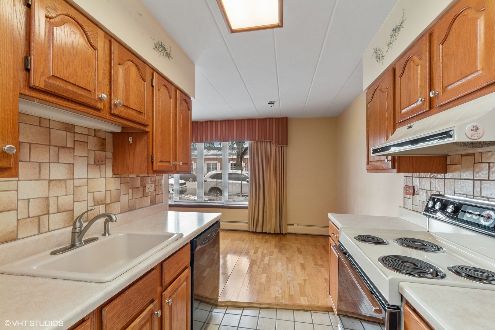 701 Busse Highway, Unit 1A Park Ridge, IL 60068 - Photo 11 of 15 a kitchen with stainless steel appliances granite countertop a sink stove and cabinets