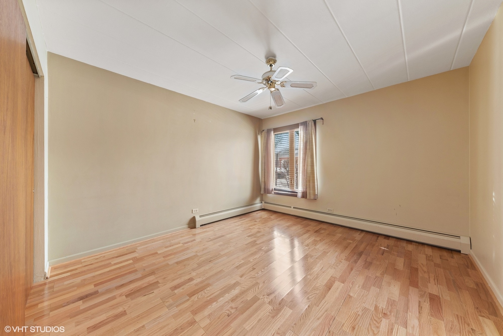 701 Busse Highway, Unit 1A Park Ridge, IL 60068 - Photo 13 of 15 wooden floor in an empty room with a window
