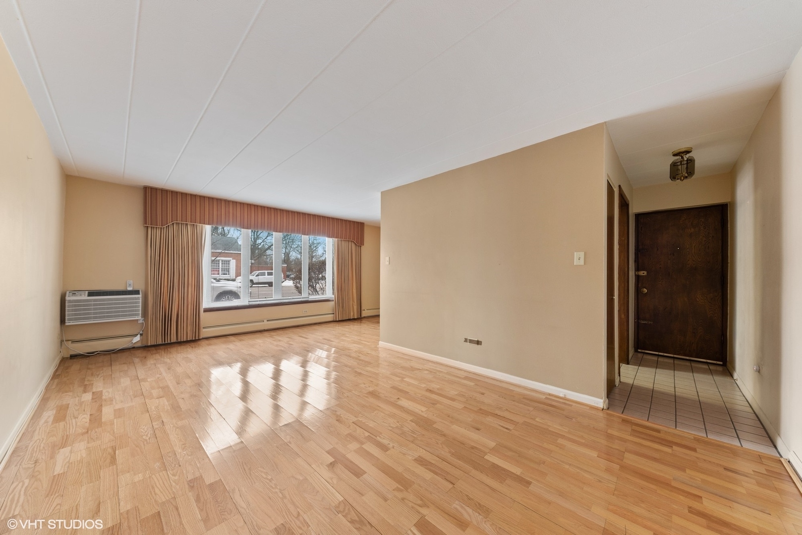 701 Busse Highway, Unit 1A Park Ridge, IL 60068 - Photo 5 of 15 wooden floor in an empty room with a window