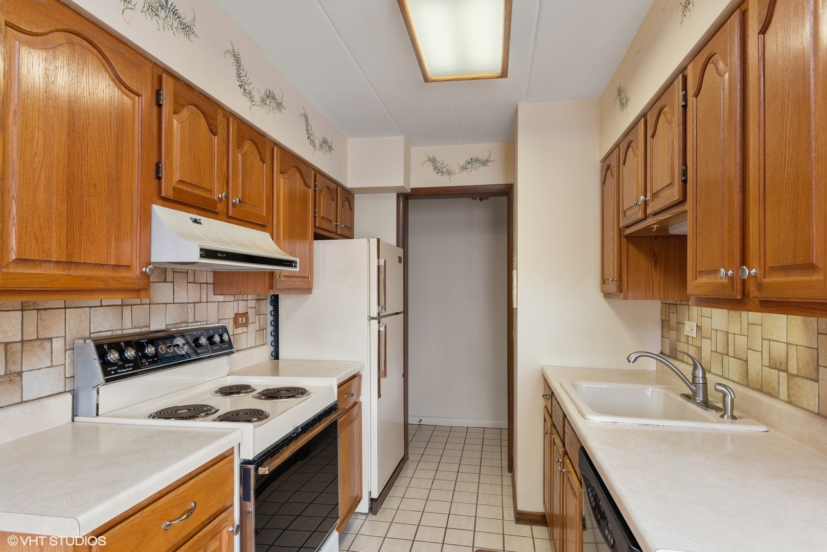 701 Busse Highway, Unit 1A Park Ridge, IL 60068 - Photo 10 of 15 a kitchen with stainless steel appliances granite countertop a sink stove and refrigerator