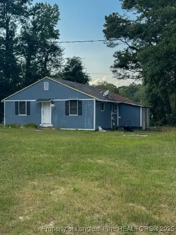 a front view of house with yard and green space