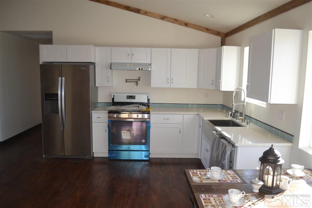 1100 McLean Road Fallon, NV 89406 - Photo 4 of 9 a kitchen with granite countertop a refrigerator stove and sink
